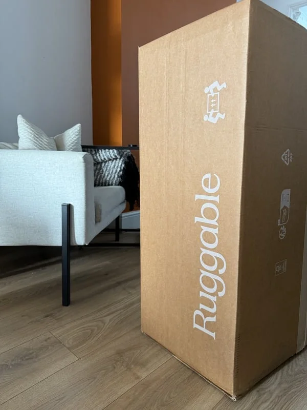 Ruggable branded cardboard box on a wooden living room floor